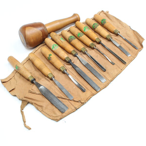 Set of wooden-handled chisels on a tool roll with a white background