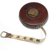 Vintage tape measure with leather case on a white background
